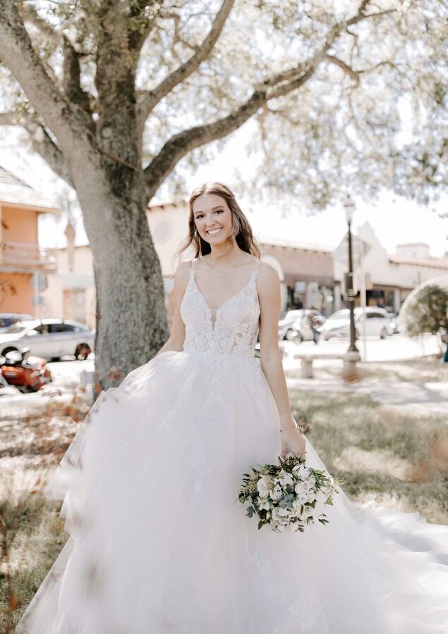 A smiling bride under the oak trees